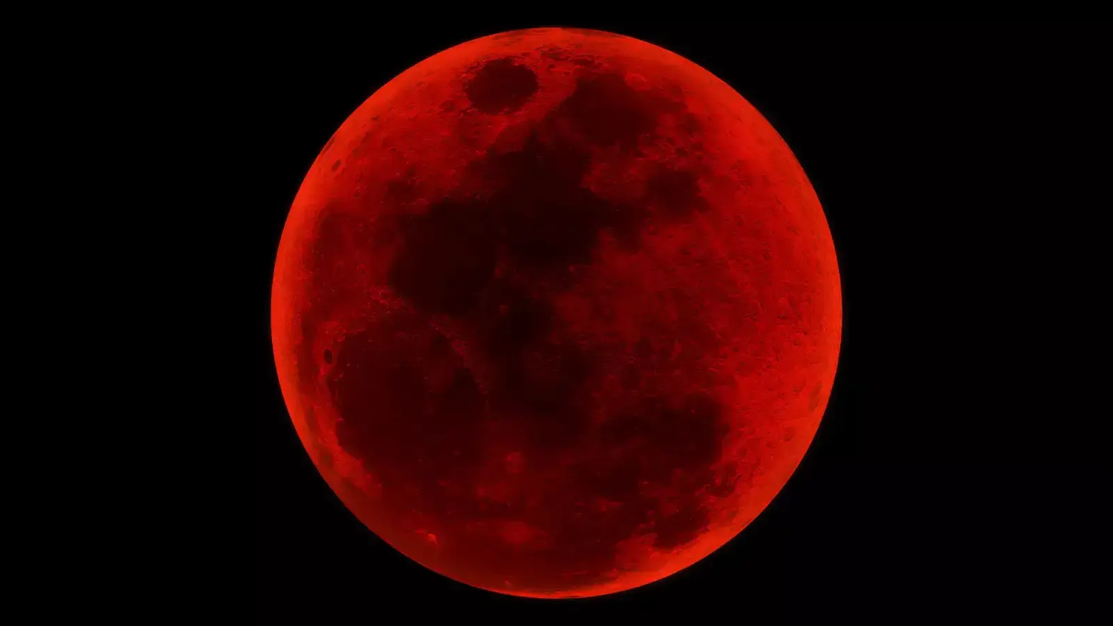 A deep red, dramatic full 'Blood Moon' showing the dark lunar maria, captured during the peak of a total lunar eclipse against a pure black background