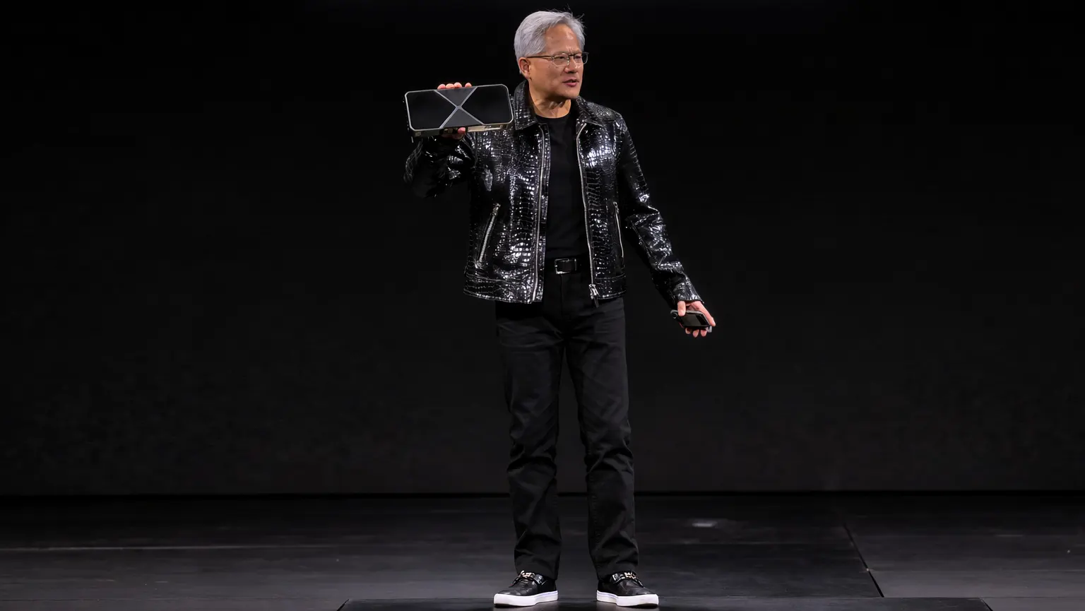Nvidia CEO Jensen Huang holding a Blackwell GB200 GPU during a 2025 keynote presentation