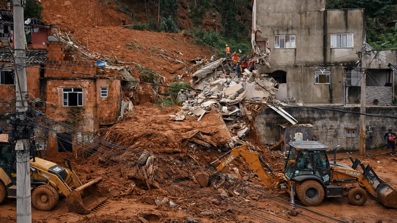 Rescue workers and excavators clearing debris after a deadly landslide caused by severe flooding in Juiz de Fora, Minas Gerais, Brazil, February 2026