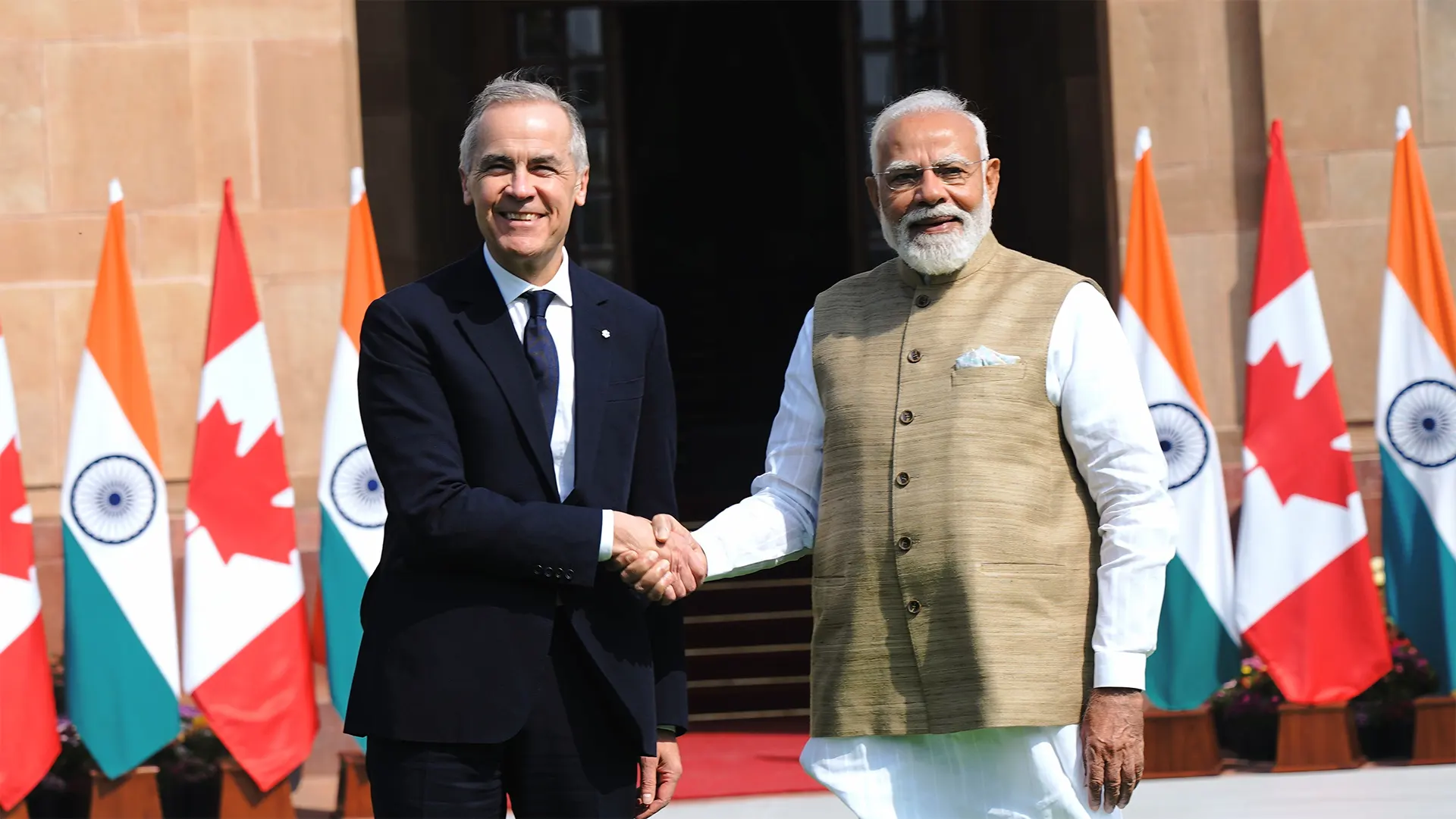 Prime Minister Narendra Modi and Canadian PM Mark Carney shake hands after signing the uranium supply deal in New Delhi