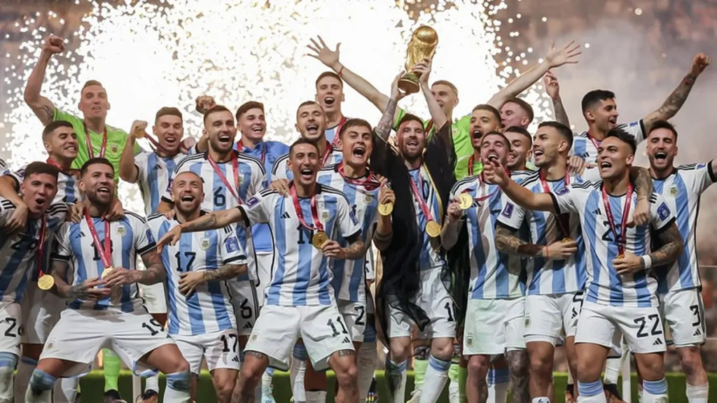 Lionel Messi and the Argentina national team celebrating with the FIFA World Cup trophy after defeating France in the 2022 Qatar final