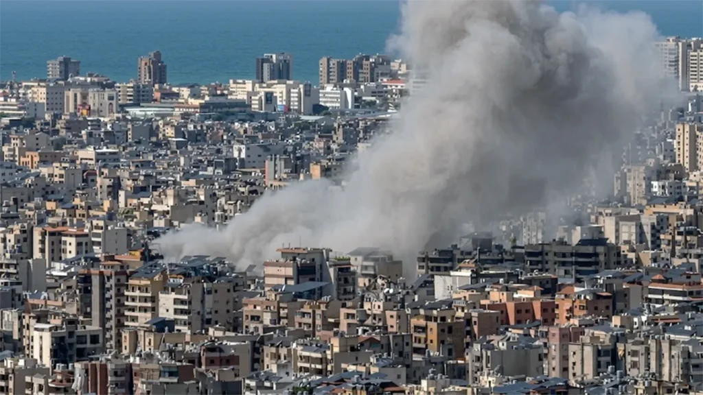 A high-resolution aerial view of a massive smoke plume rising from a residential neighborhood in Beirut, Lebanon, following an airstrike during the 2026 conflict