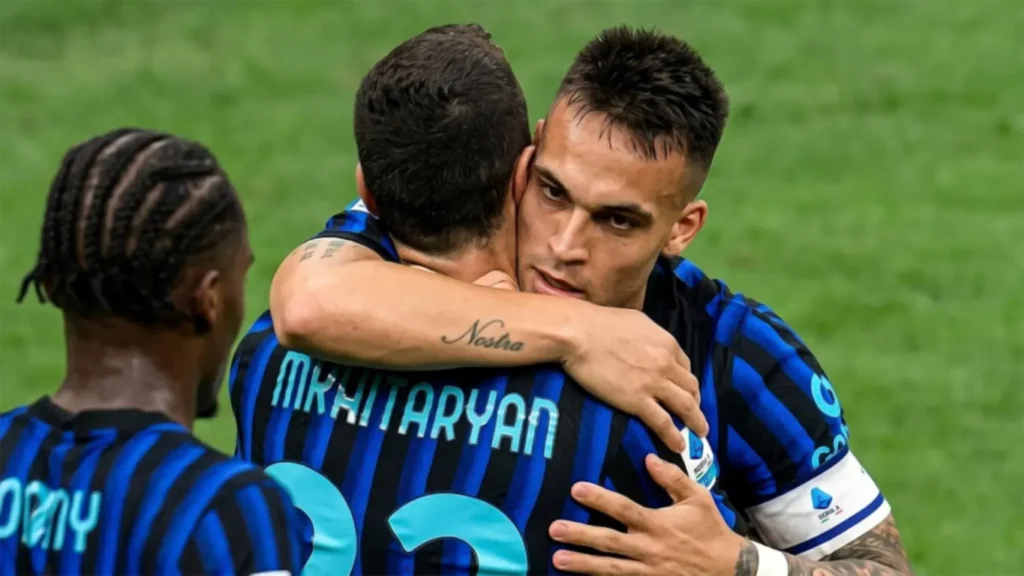 A high-resolution close-up of Inter Milan captain Lautaro Martínez embracing Henrikh Mkhitaryan during their 2026 Scudetto-winning match against Parma