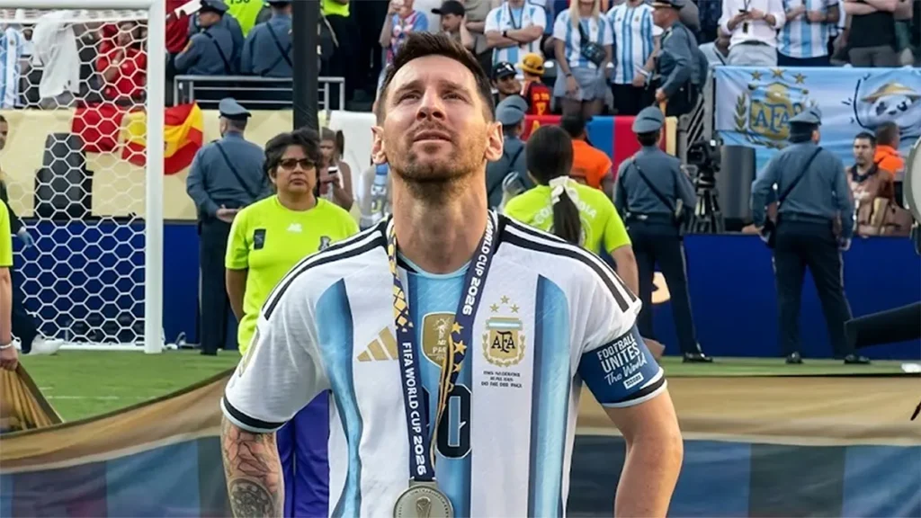 Lionel Messi looking up wearing his Argentina kit and runner-up medal after the 2026 World Cup final match.